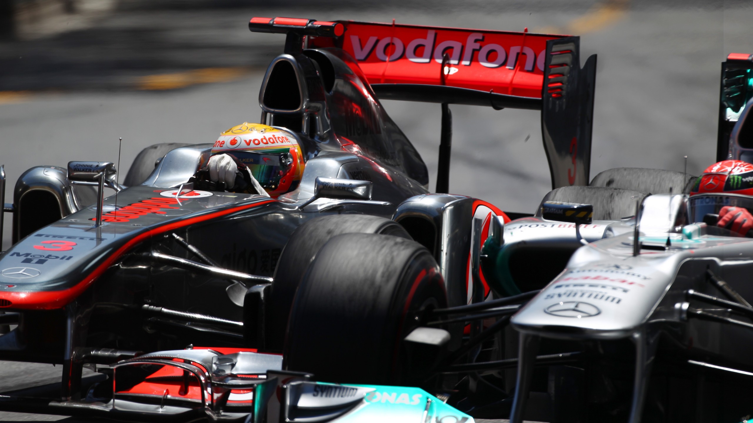 Lewis Hamilton and Michael Schumacher go wheel-to-wheel at the 2011 Monaco Grand Prix.