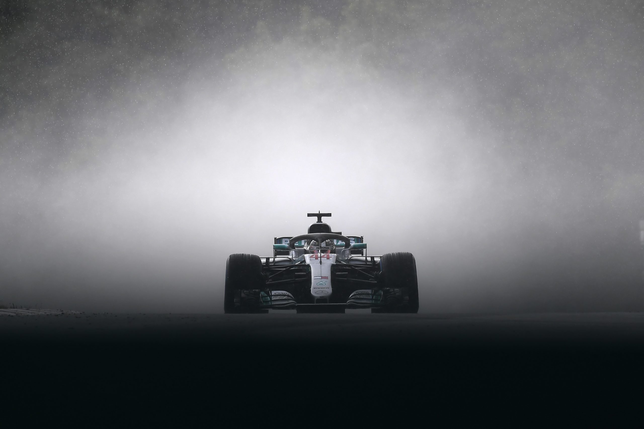 Lewis Hamilton in a cloud of spray.