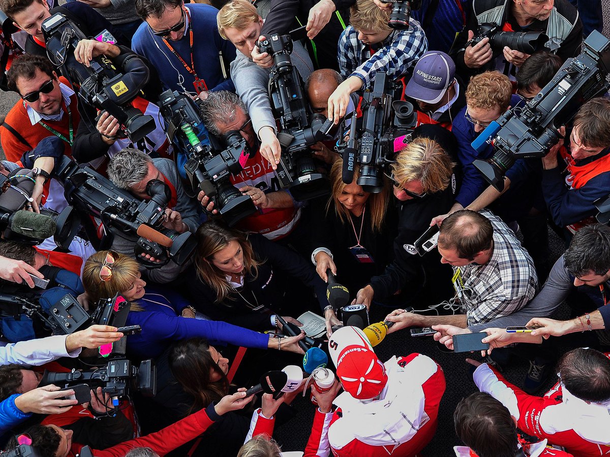 Sebastian Vettel surrounded by the press.