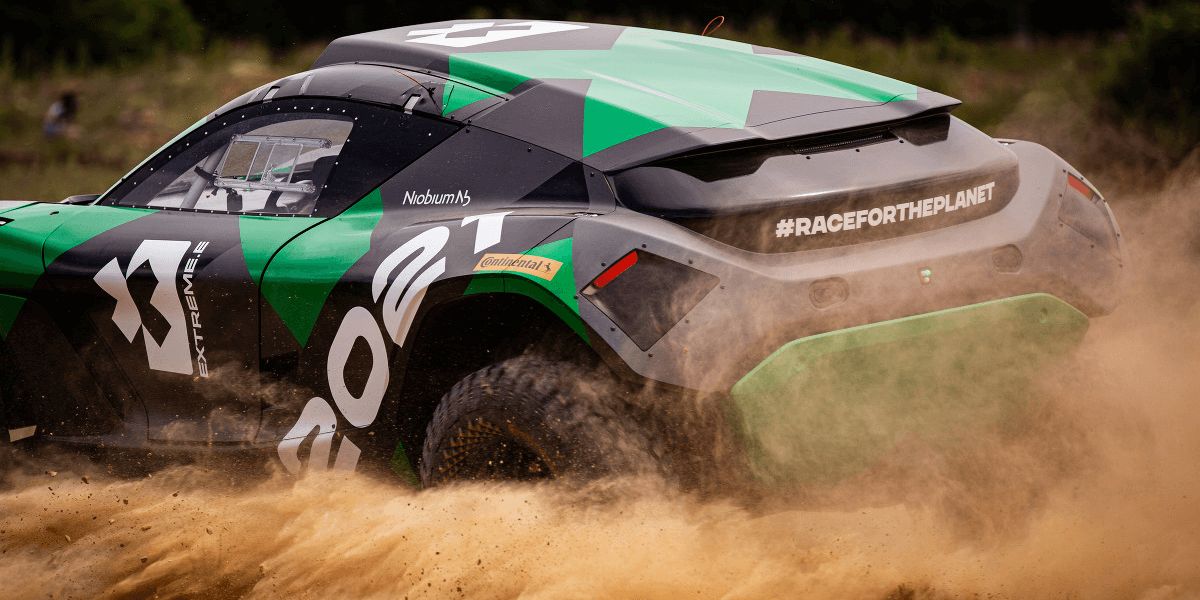 An Extreme E car kicking up dirt.