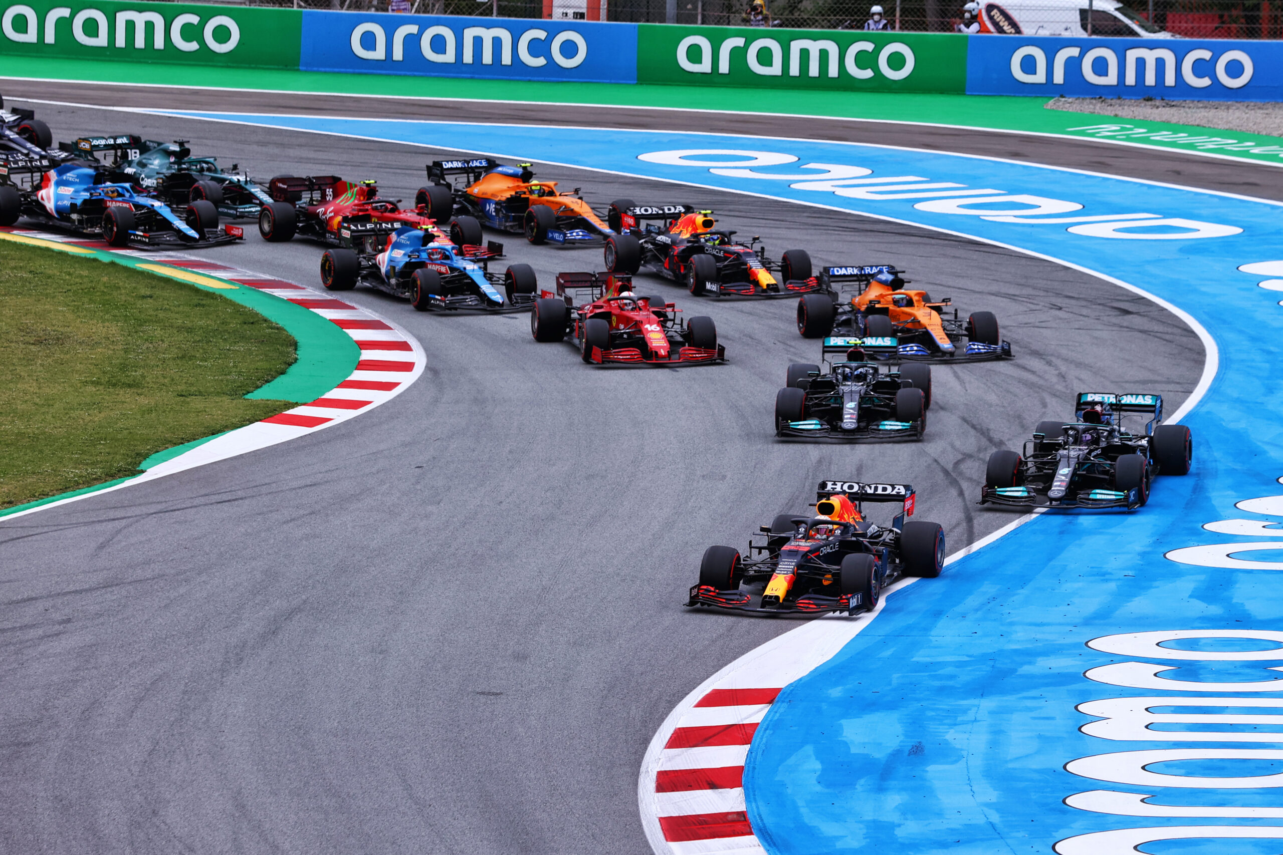 Max Verstappen leaves the first corner in the lead.