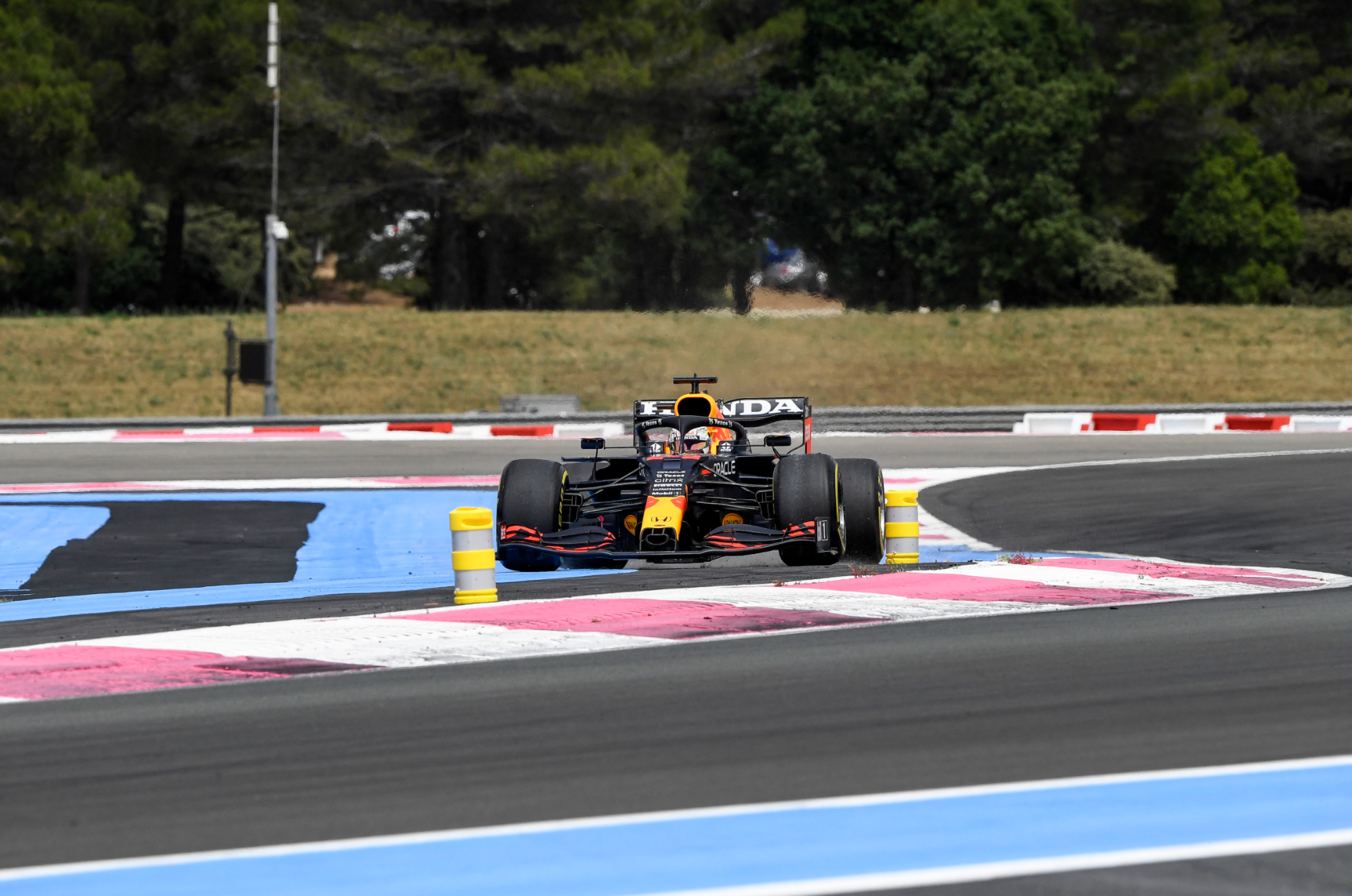 Max Verstappen runs wide at the first corner.