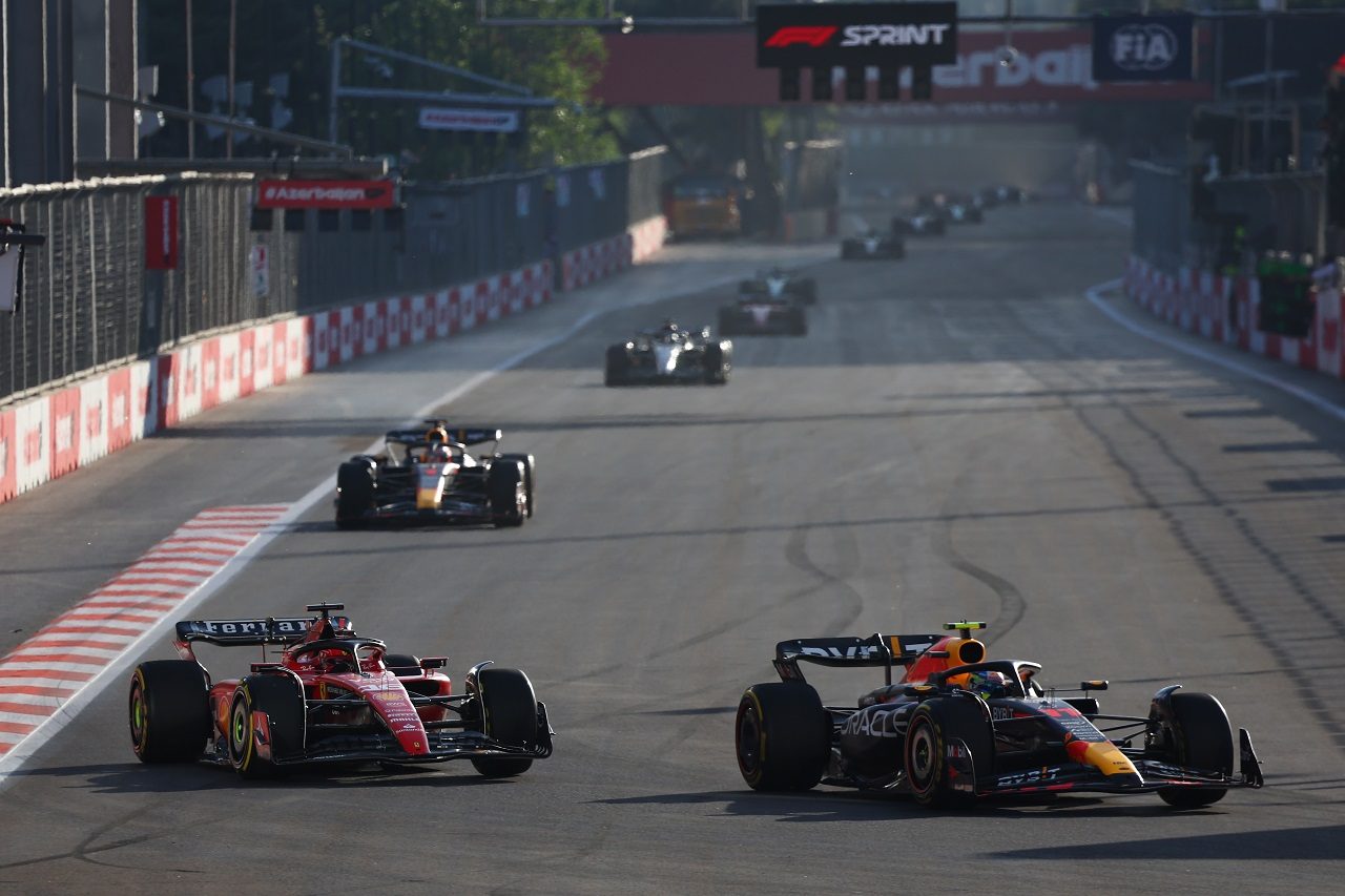 Charles Leclerc being passed by Sergio  Pérez at the Formula 1 Sprint in Baku.